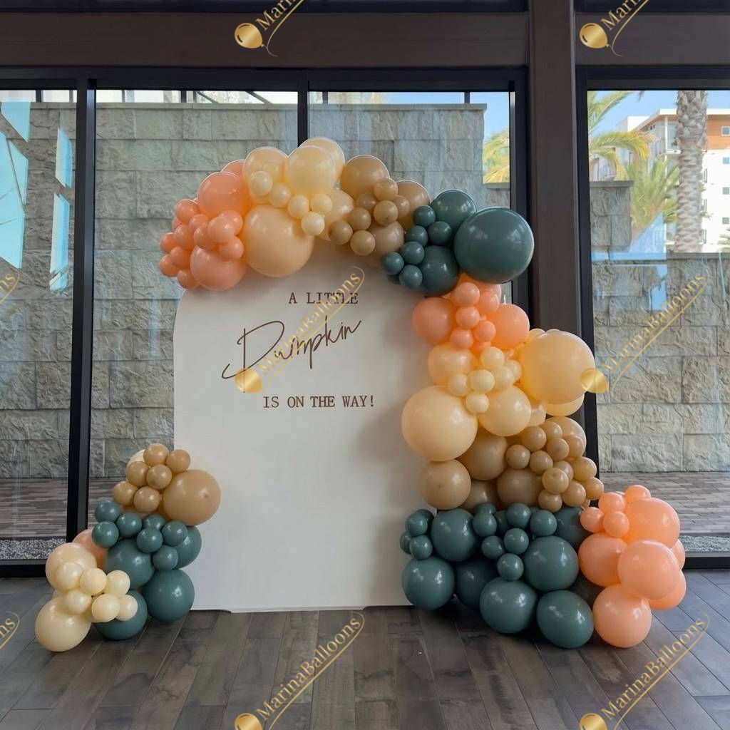 A cozy fall-themed photo backdrop perfect for baby showers and autumn celebrations. Soft neutrals, warm tones, and a charming balloon frame create the sweetest spot for memorable pictures.