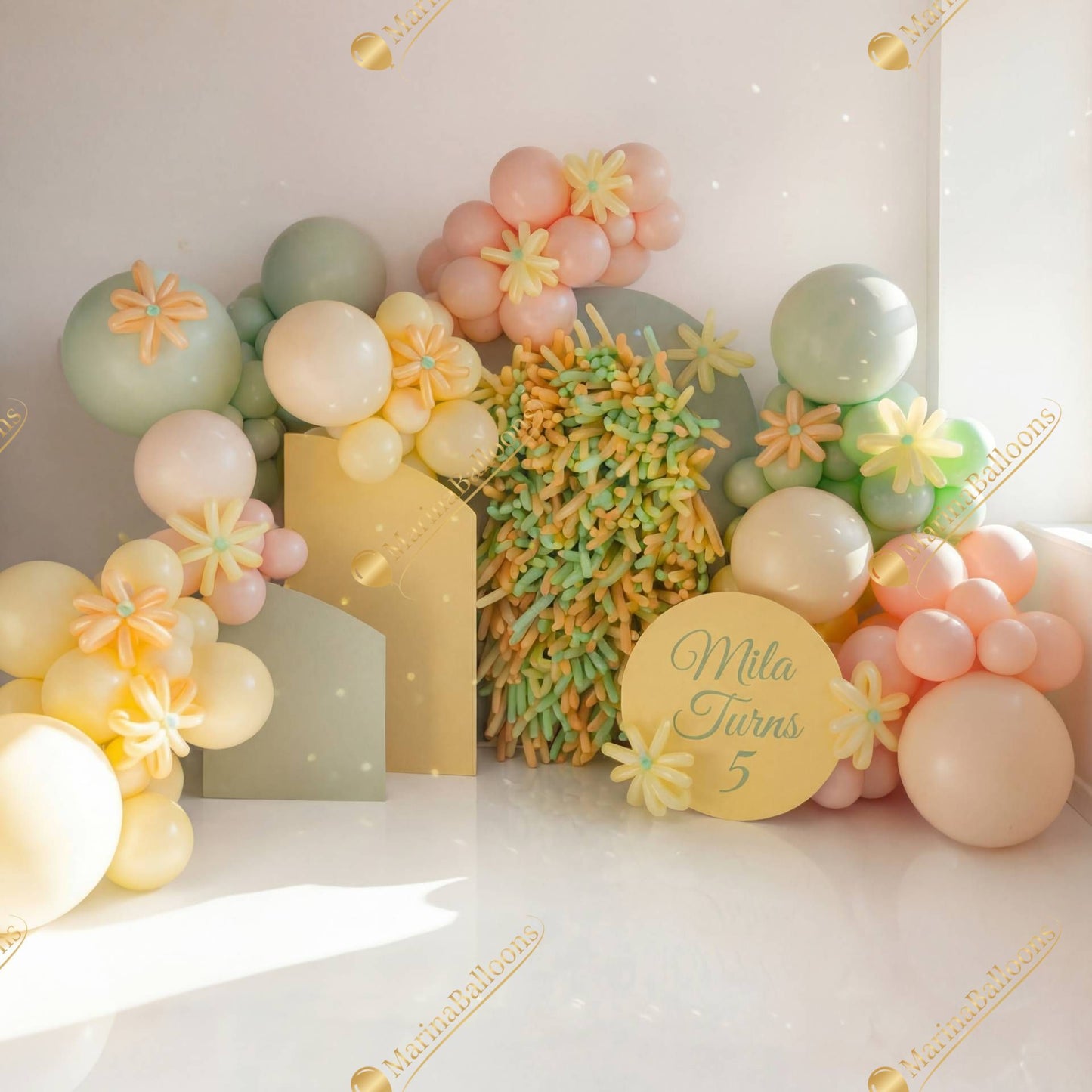 A sweet pastel balloon installation with floral details - a soft and cheerful photo zone for a little girl’s birthday.