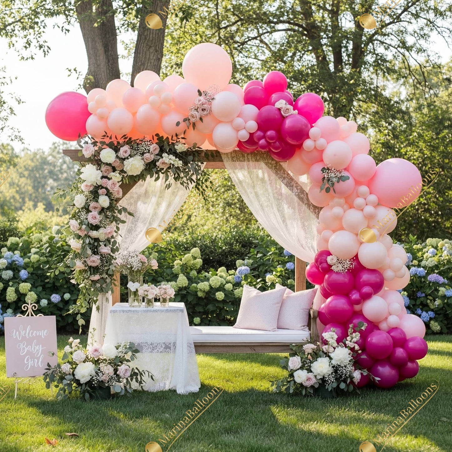 A romantic outdoor setup with soft pink balloons, lush florals, and a dreamy gazebo - the perfect backdrop for a baby shower or garden celebration.