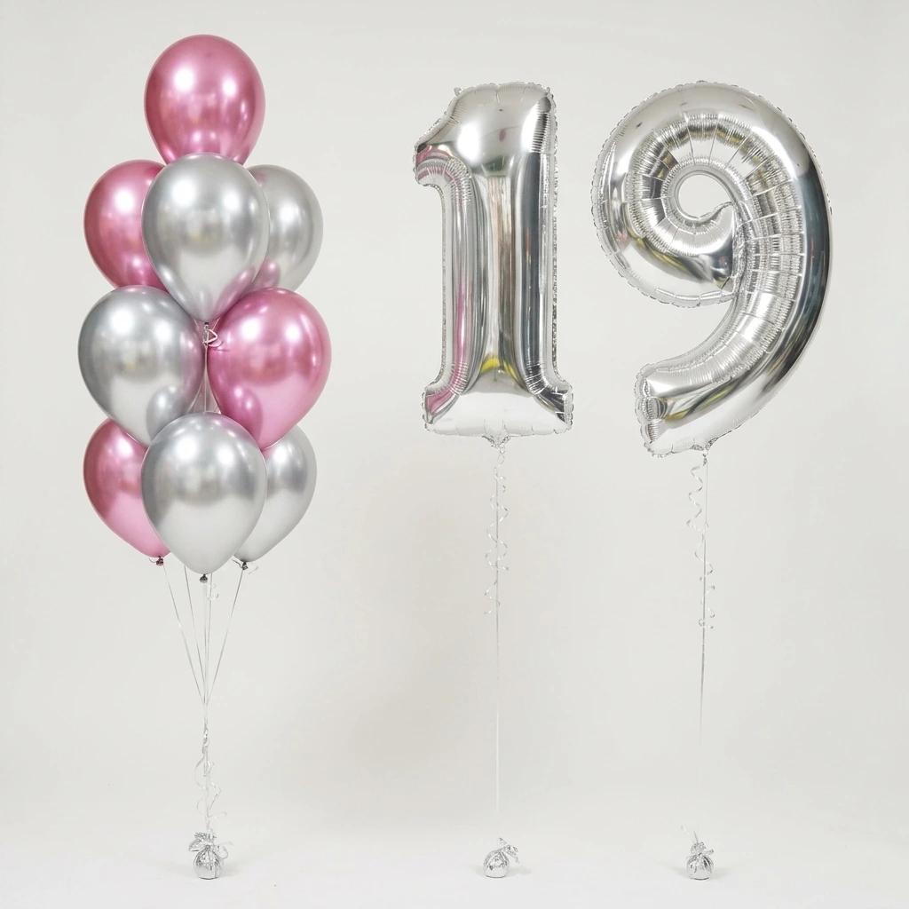 A set of party balloons including a cluster of metallic pink and silver latex balloons, a large silver foil balloons shaped like the numbers 19!