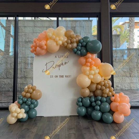 A cozy fall-themed photo backdrop perfect for baby showers and autumn celebrations. Soft neutrals, warm tones, and a charming balloon frame create the sweetest spot for memorable pictures.