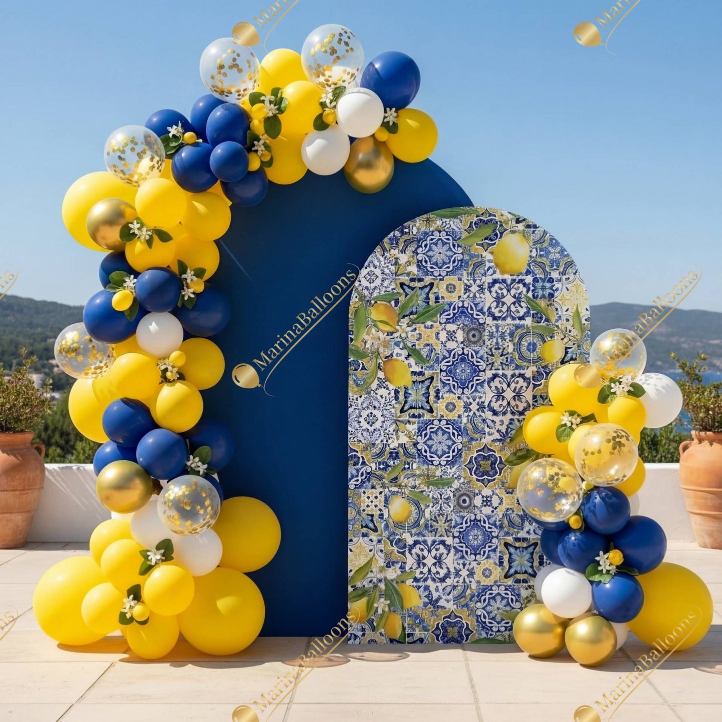A vibrant Amalfi-inspired setup with blue-and-yellow balloons and lemon-patterned backdrops - a bright, Mediterranean-style celebration.