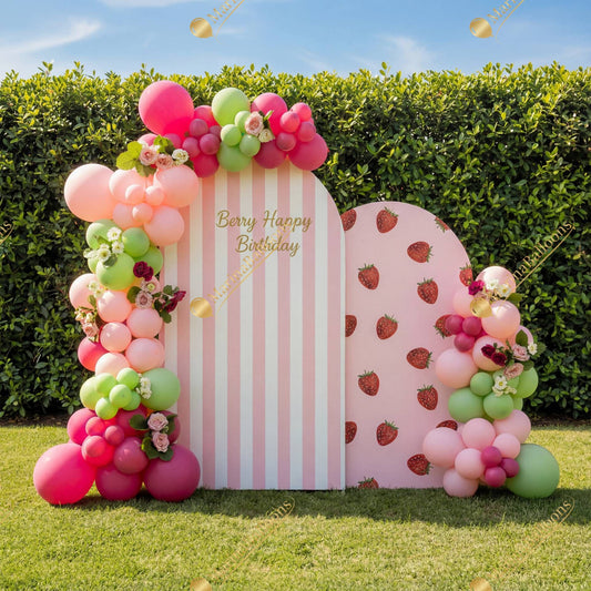 A sweet strawberry-themed birthday setup with pink and green balloons, florals, and playful backdrops - perfect for a fun outdoor celebration.