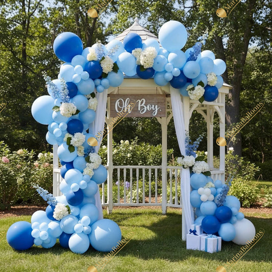 A charming blue baby-shower setup with lush florals and balloon garlands, styled around a garden gazebo - ideal for welcoming a baby boy.