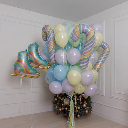 A sweet winter setup featuring pastel balloons, striped candy canes, shimmering clear spheres, and adorable oversized ice skates. Soft, playful, and full of holiday charm - perfect for kids’ celebrations, cozy Christmas photos, and magical winter moments.