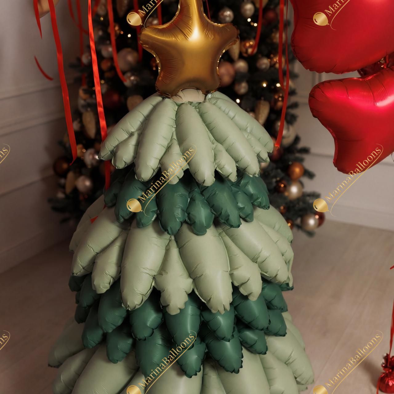 A festive New Year setup featuring floating green ceiling balloons, red satin bows, and a charming balloon Christmas tree. Warm, bright, and instantly joyful - the perfect backdrop for holiday photos and cozy celebrations.