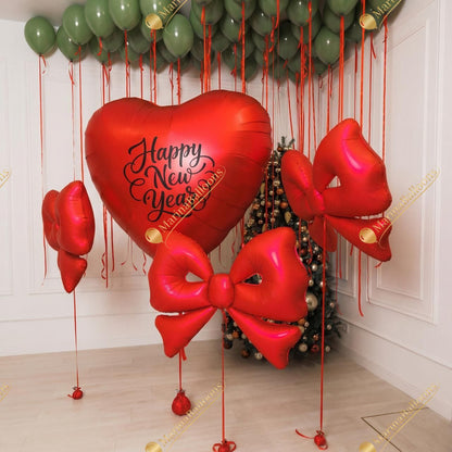 A festive New Year setup featuring floating green ceiling balloons, red satin bows, and a charming balloon Christmas tree. Warm, bright, and instantly joyful - the perfect backdrop for holiday photos and cozy celebrations.