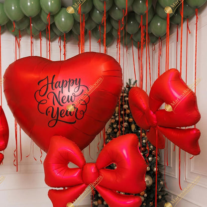 A festive New Year setup featuring floating green ceiling balloons, red satin bows, and a charming balloon Christmas tree. Warm, bright, and instantly joyful - the perfect backdrop for holiday photos and cozy celebrations.