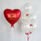 Red heart balloon with white balloons