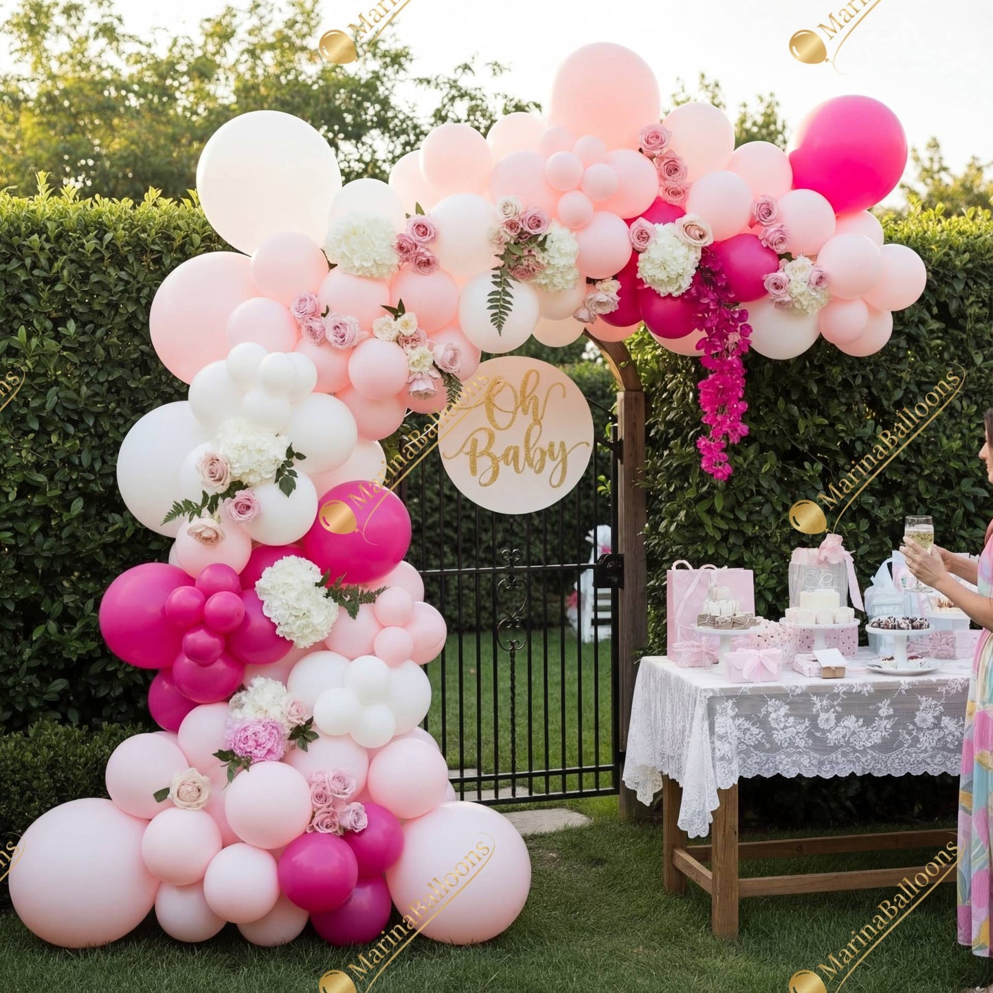 A soft pink baby-shower arch with florals and pastel balloons - a sweet, elegant backdrop for welcoming a baby girl.