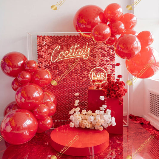 A bold and luxurious red cocktail setup featuring glossy balloons, a shimmer wall, neon signage, and elegant floral accents - the perfect statement decor for parties, corporate events, and holiday celebrations.
