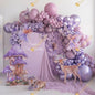 A dreamy fairy-garden setup in soft lavender tones with whimsical fairies, butterflies, woodland animals, and elegant balloon decor - the perfect magical backdrop for a little girl’s birthday.