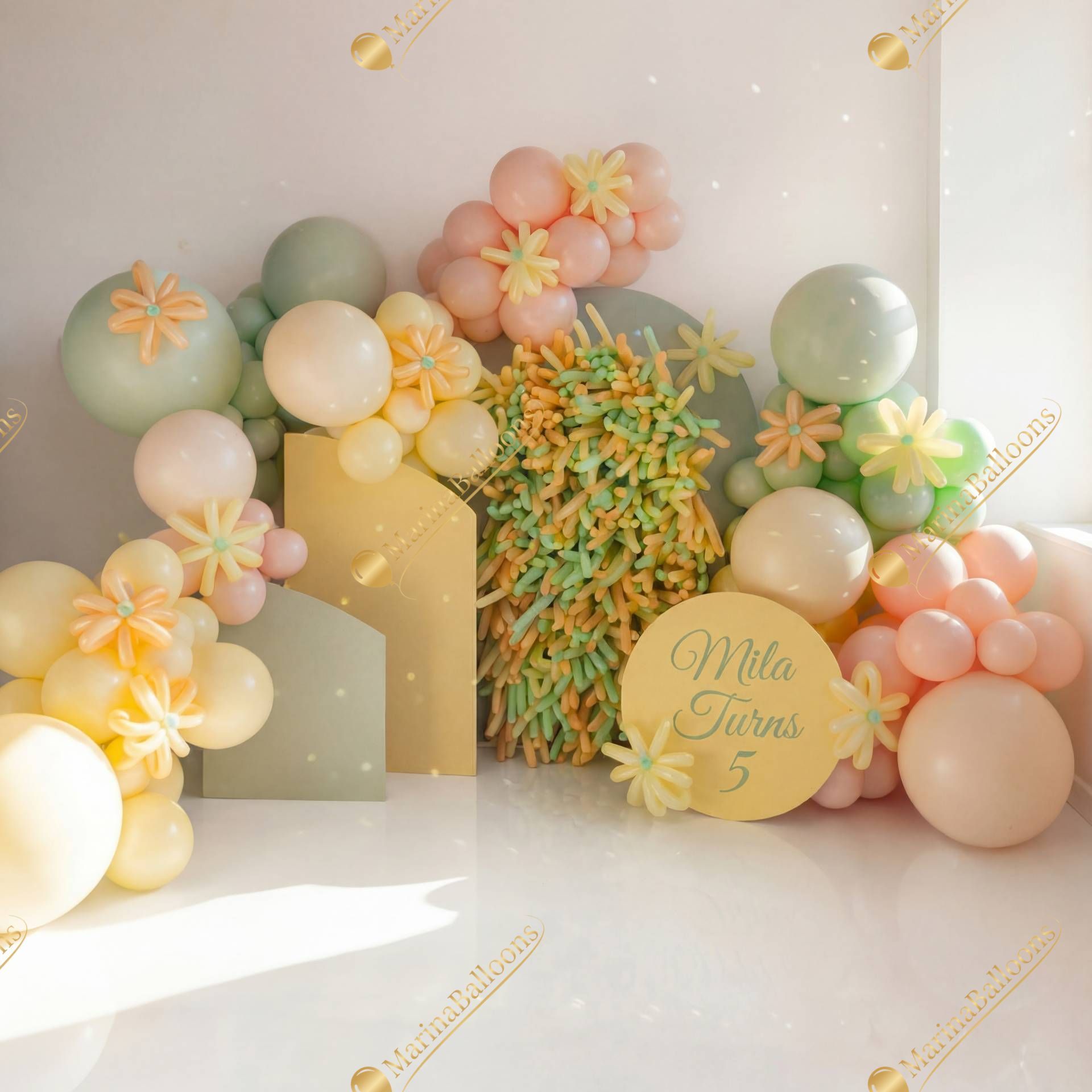 A sweet pastel balloon installation with floral details - a soft and cheerful photo zone for a little girl’s birthday.
