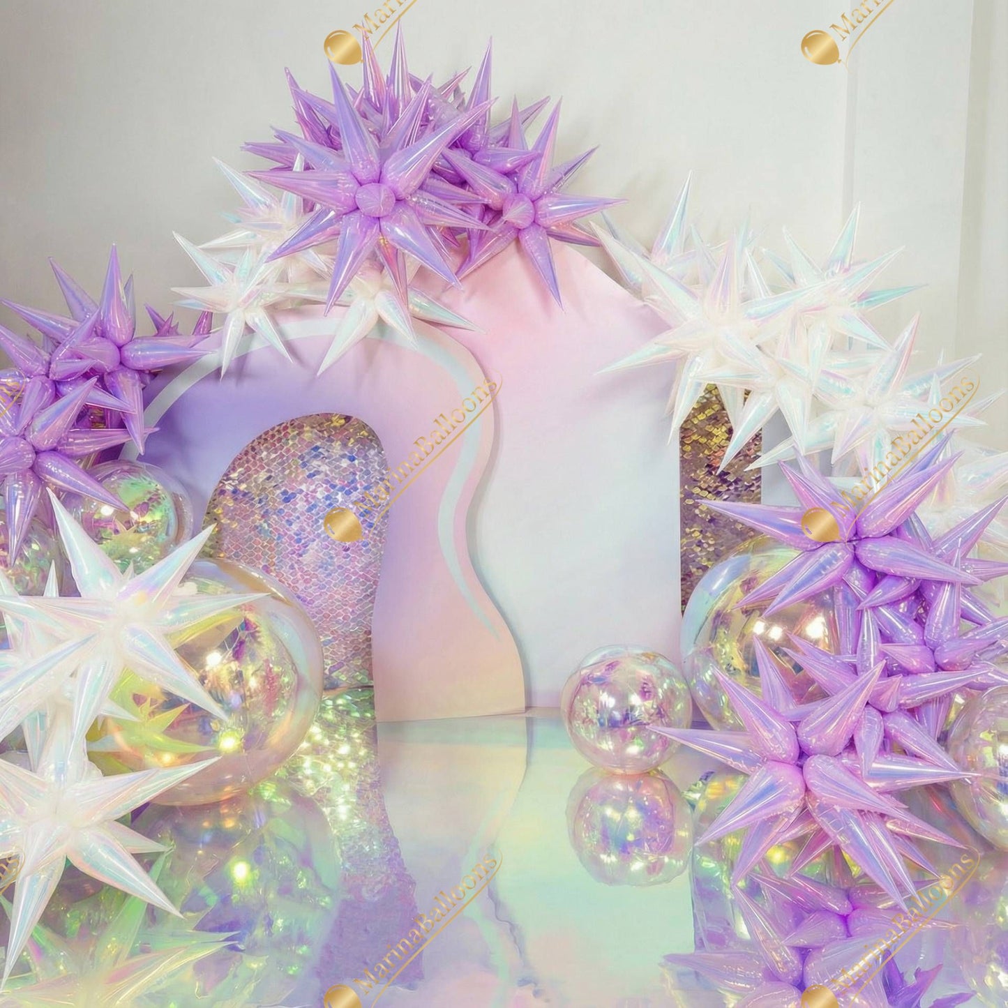 A dreamy iridescent setup with pastel star balloons, glowing spheres, and soft holographic tones - a magical, futuristic photo zone perfect for birthdays and themed parties.