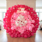 A vibrant pink balloon flower wall with floral accents - a stunning centerpiece for any birthday celebration.