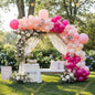 A romantic outdoor setup with soft pink balloons, lush florals, and a dreamy gazebo - the perfect backdrop for a baby shower or garden celebration.
