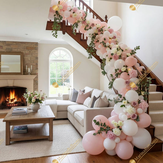 A romantic indoor balloon garland with soft pink tones, lush florals, and greenery - perfect for elevating any celebration.