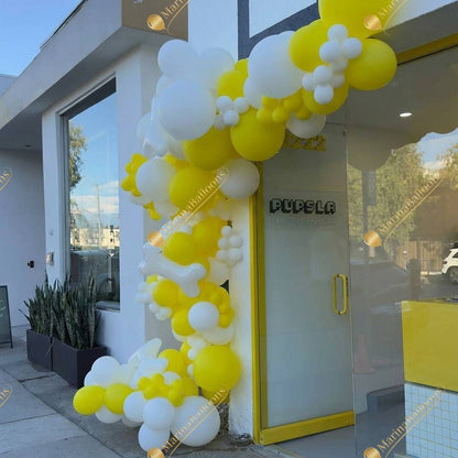 A bold yellow-and-white balloon installation for storefronts - a fresh, high-impact look that draws attention and boosts foot traffic.