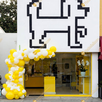 A bold yellow-and-white balloon installation for storefronts - a fresh, high-impact look that draws attention and boosts foot traffic.