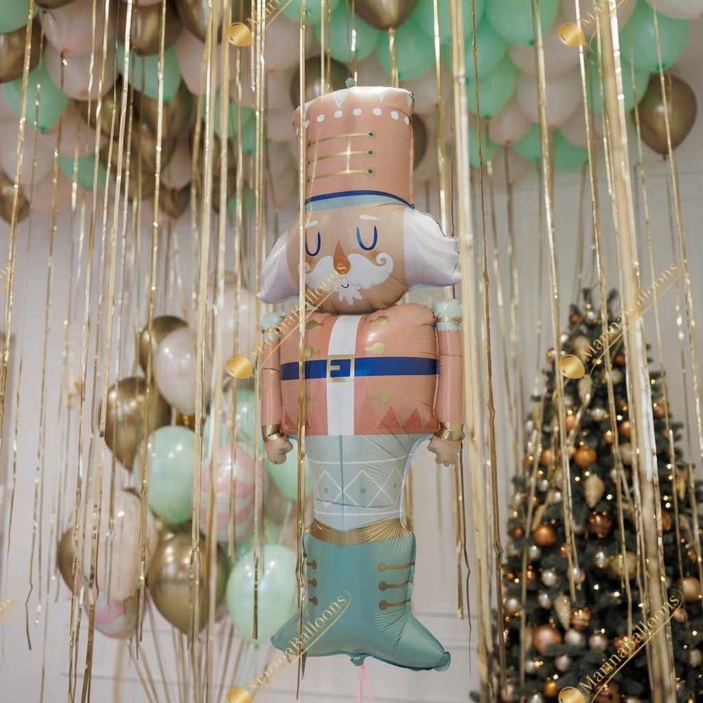 A soft pastel Christmas setup featuring floating ceiling balloons, golden ribbons, and adorable Nutcracker characters. Delicate, magical, and full of holiday charm - the perfect backdrop for kids’ celebrations, family photos, and festive winter events.