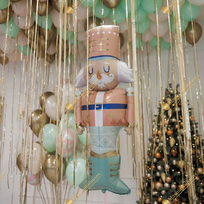 A soft pastel Christmas setup featuring floating ceiling balloons, golden ribbons, and adorable Nutcracker characters. Delicate, magical, and full of holiday charm - the perfect backdrop for kids’ celebrations, family photos, and festive winter events.